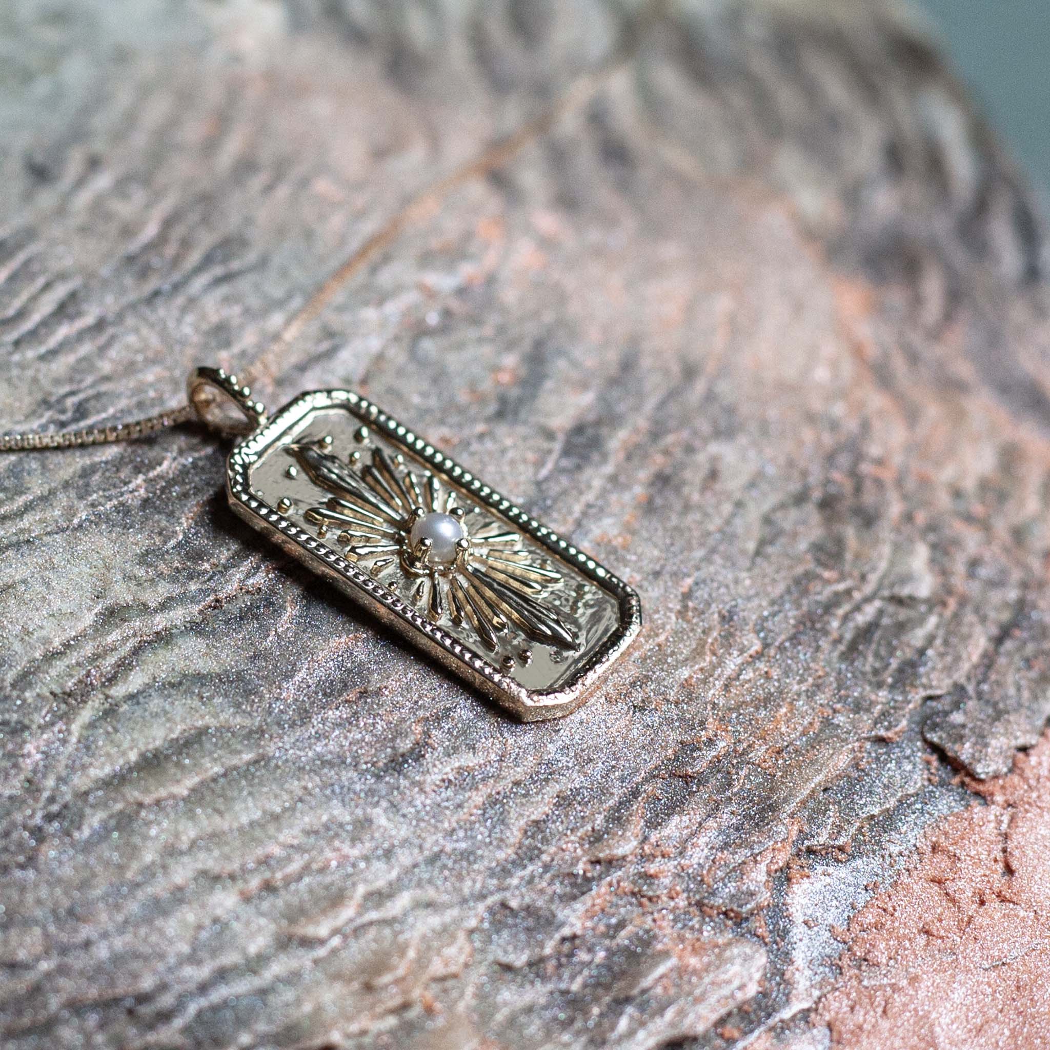 Sunburst gold pearl charm