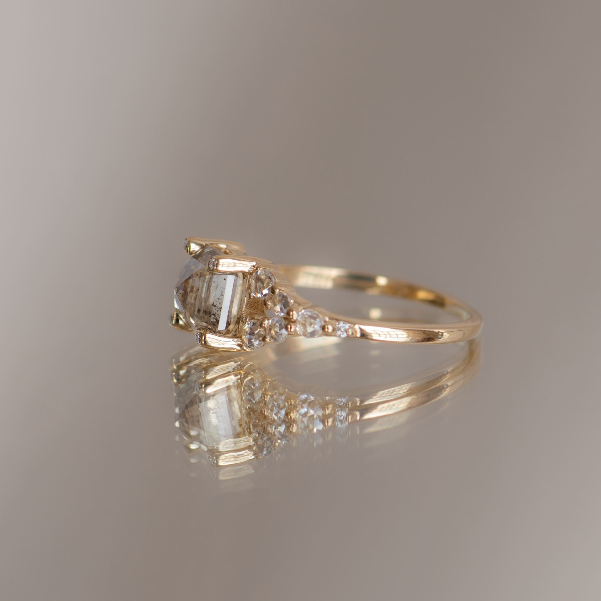 Emerald cut salt and pepper diamond engagement ring with split band, made with rose cut diamonds in 14k yellow gold.
