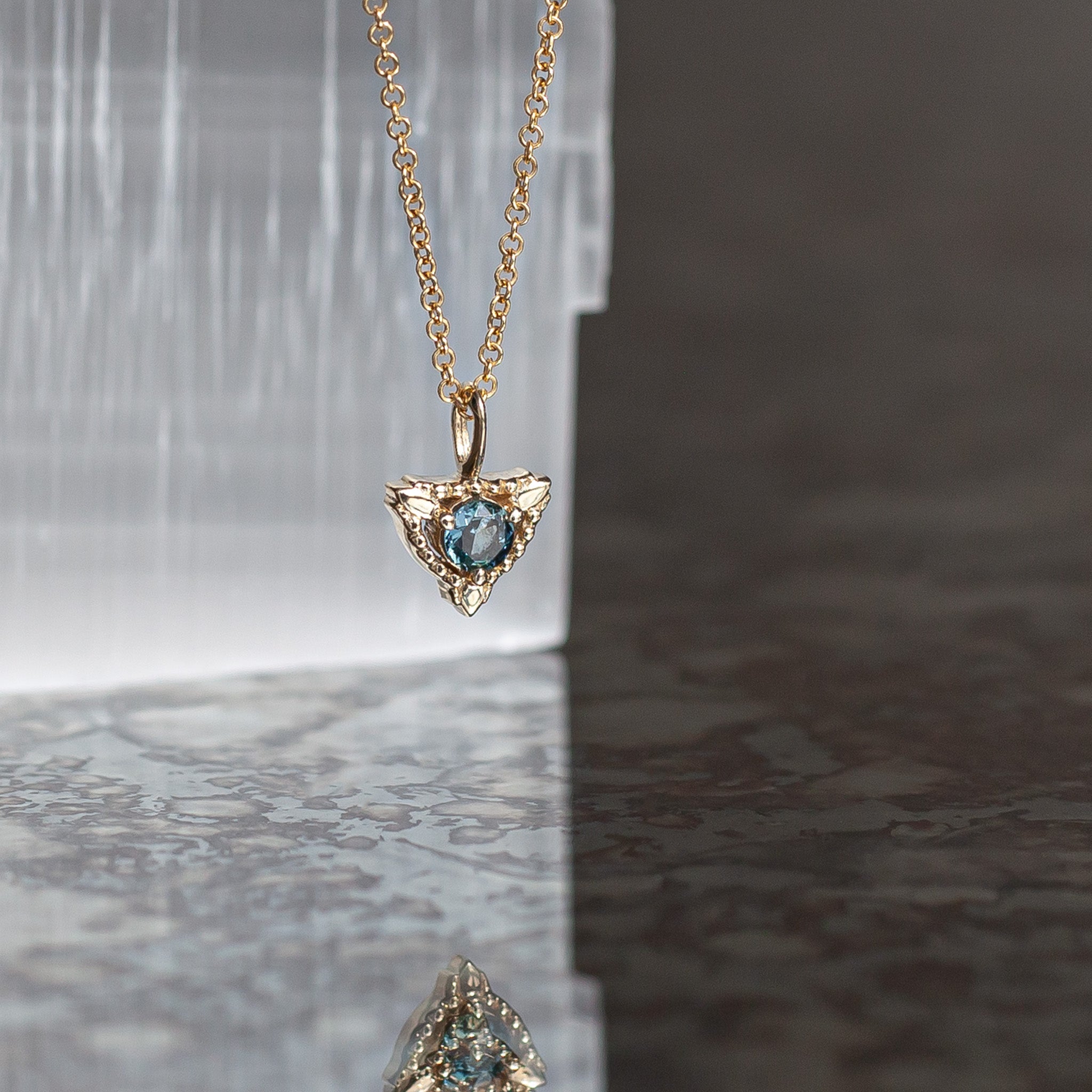 Sapphire trillium gold charm