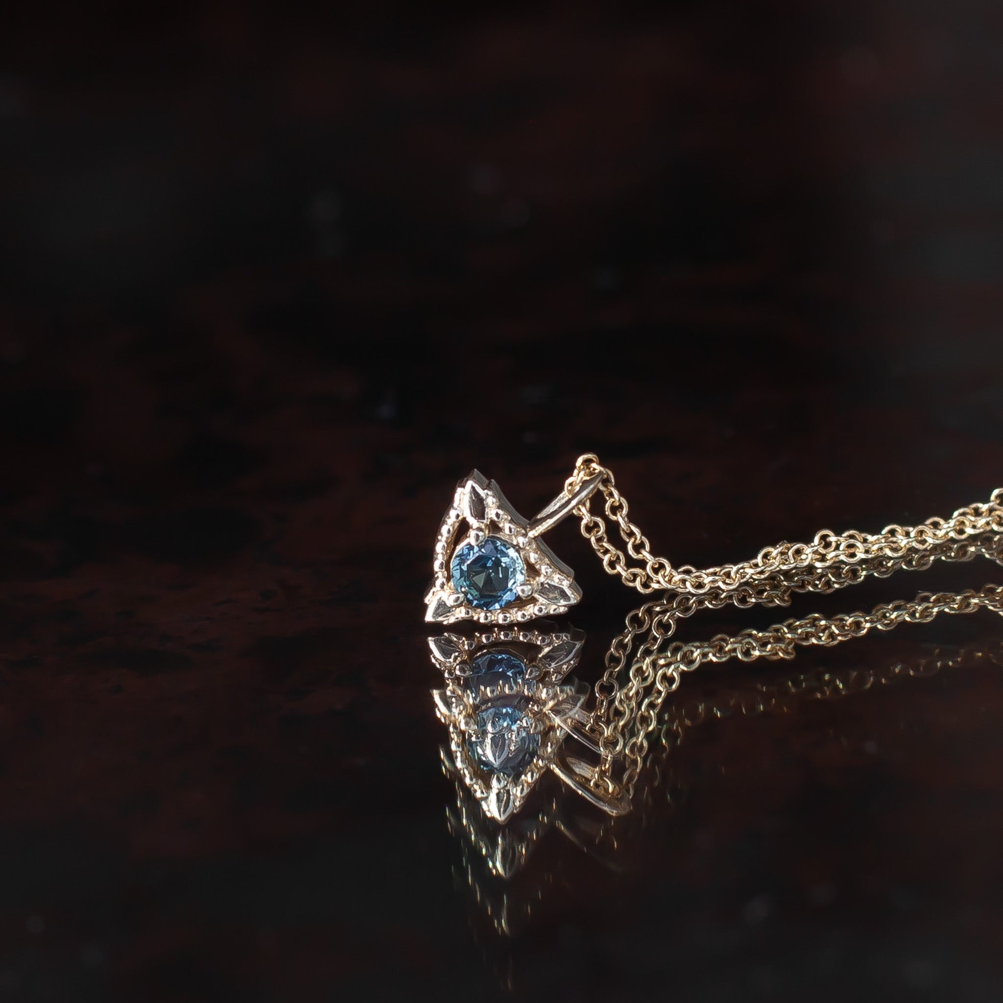 Sapphire trillium gold charm