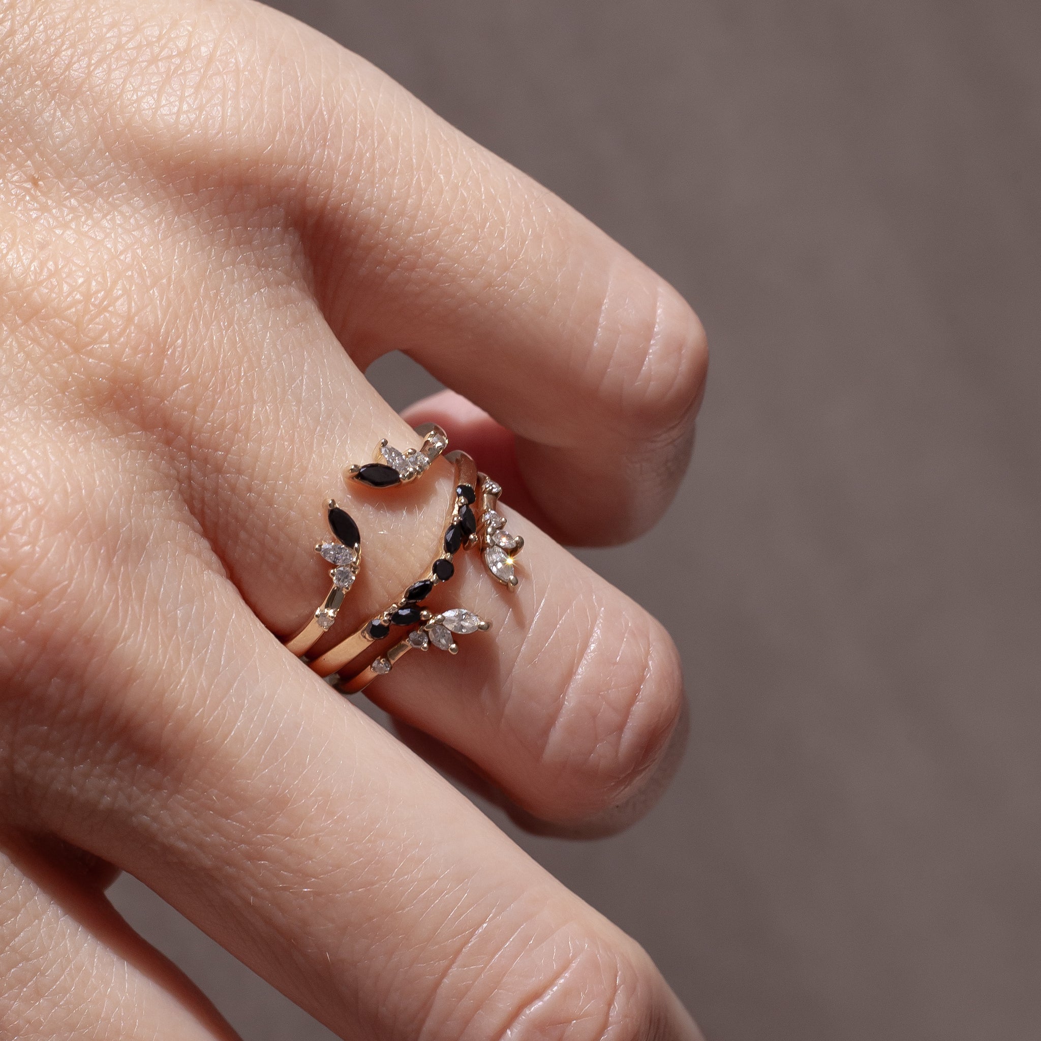 Open wedding band with black and white diamond