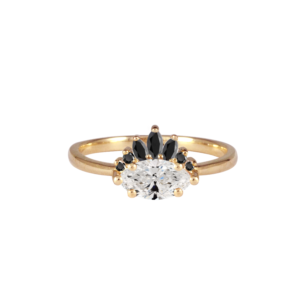 Contemporary take on a traditional marquise diamond ring featuring an East-West marquise brilliant cut diamond. The centre stone is surrounded with a diamond crown of black marquise and round brilliant diamonds. Made in solid 14k or 18K yellow gold.
