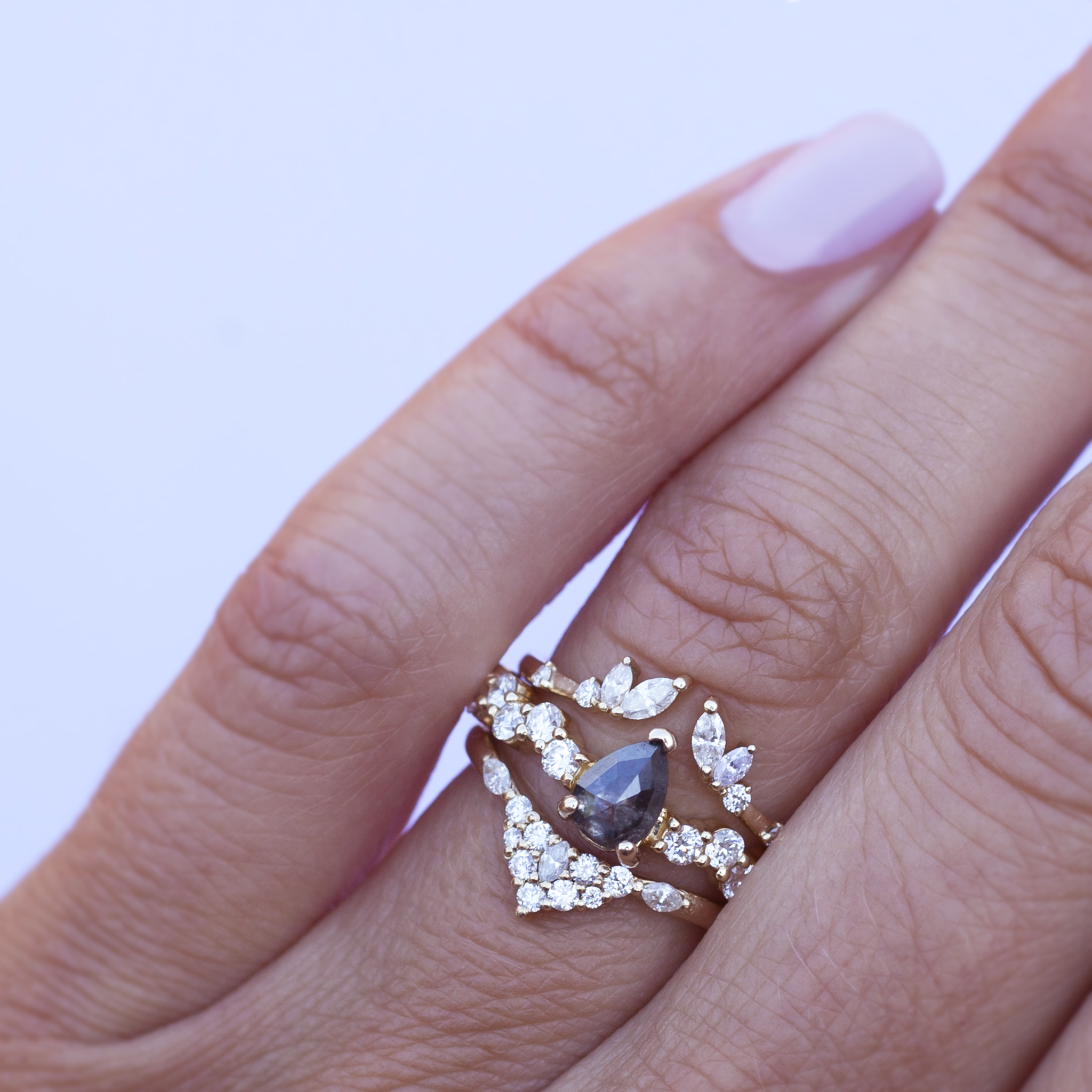 Unique salt and pepper rose cut pear diamond engagement ring, on a diamond cluster band, prong setting, made in 14k or 18k yellow gold.