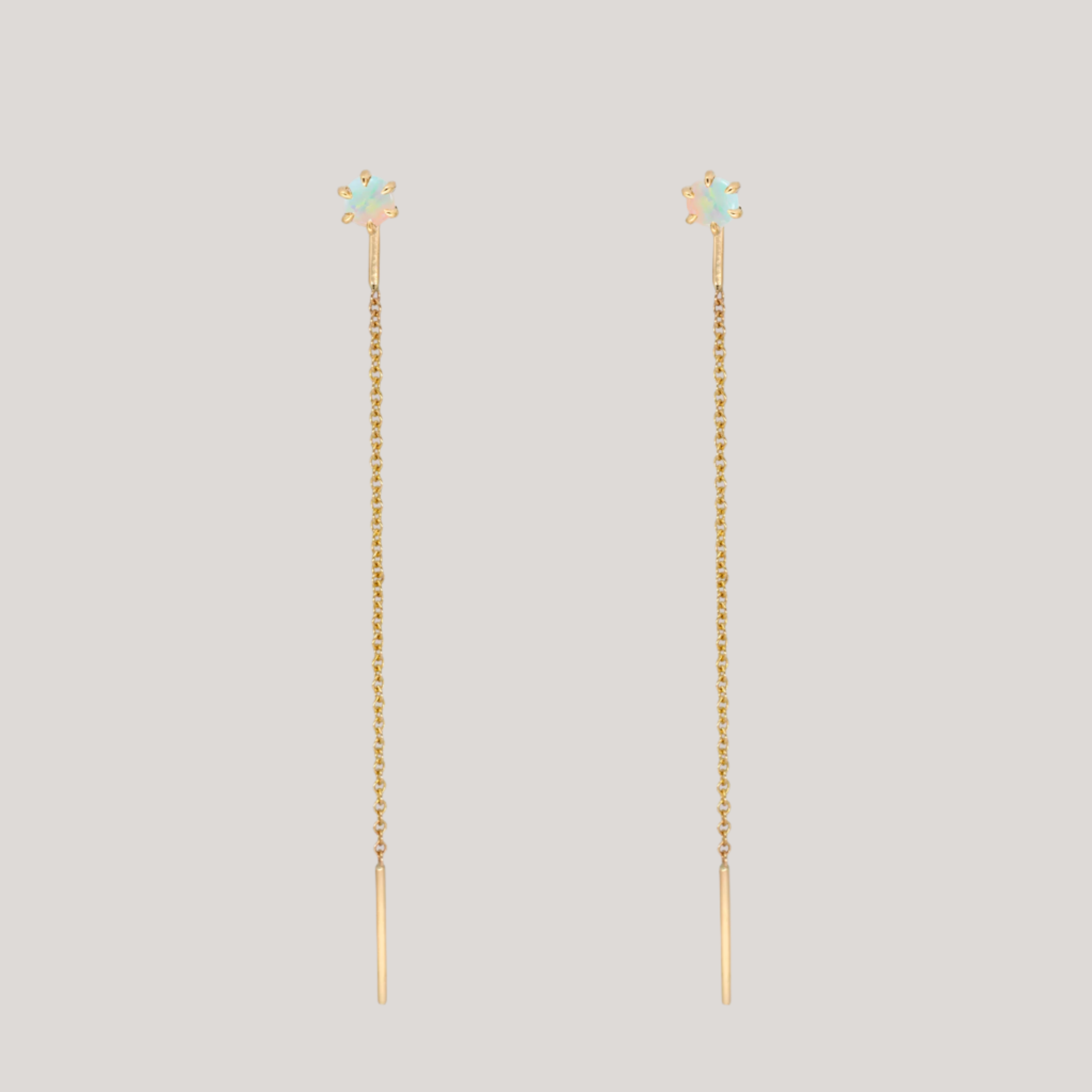 Delicate opal gold threaders, ideal for threading through multiple piercings, feature a six claw prong setting, using 14K gold.
