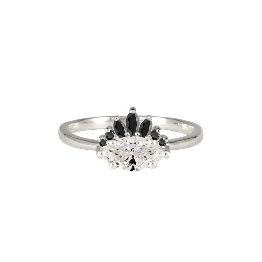 Contemporary take on a traditional marquise diamond ring featuring an East-West marquise brilliant cut diamond. The centre stone is surrounded with a diamond crown of black marquise and round brilliant diamonds. Made in solid 14k or 18K white gold.