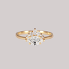 Contemporary take on a traditional marquise diamond ring features an East-West marquise diamond. The centre stone is surrounded with a diamond crown of marquise and round brilliant diamonds. Made in solid 14k or 18K yellow gold.