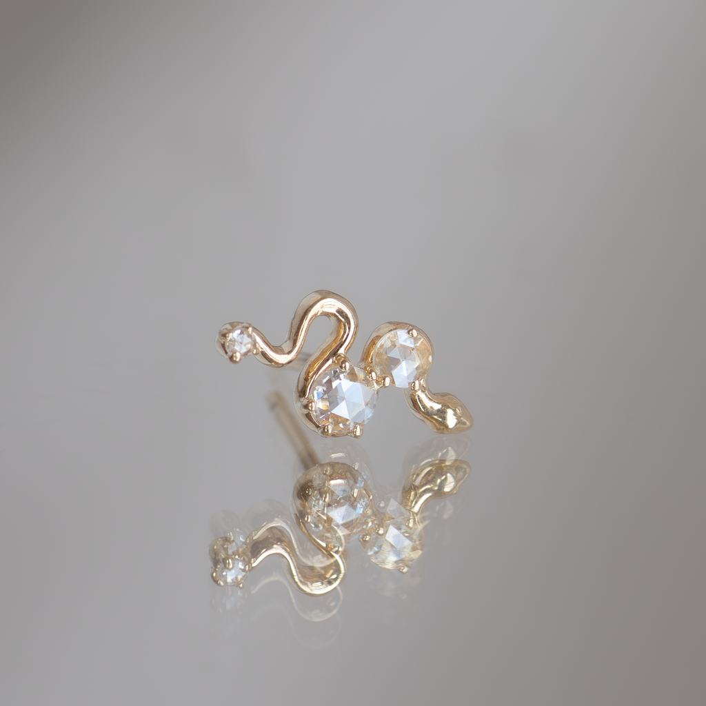 Delicate gold snake earring studs, made with 10k gold and rose cut diamonds.