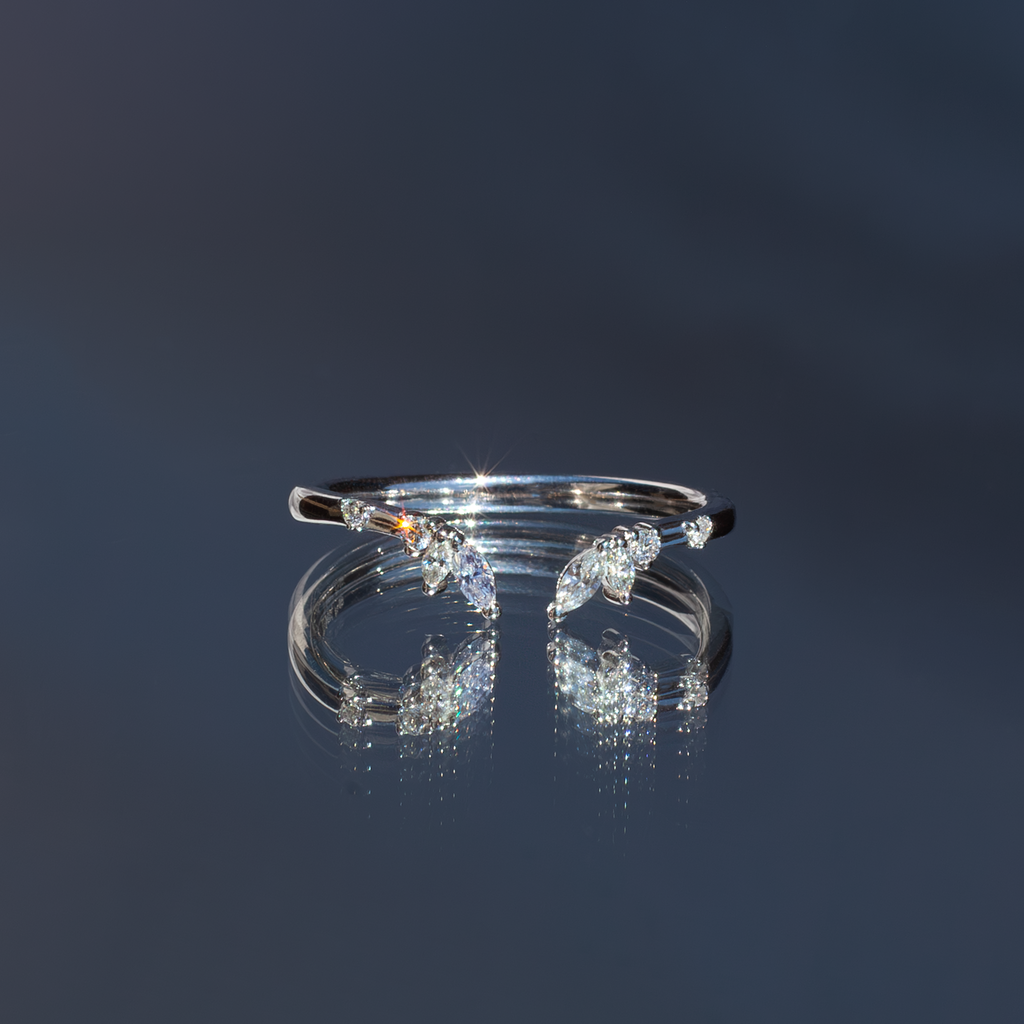 An open white diamond crown wedding band with a gentle wave to trace and pair with any engagement ring, whether it’s a solitaire or a halo. This ring is also a perfect everyday stackable ring that can be stacked with your favourite everyday staples, or worn on its own. Made in 14K white gold.