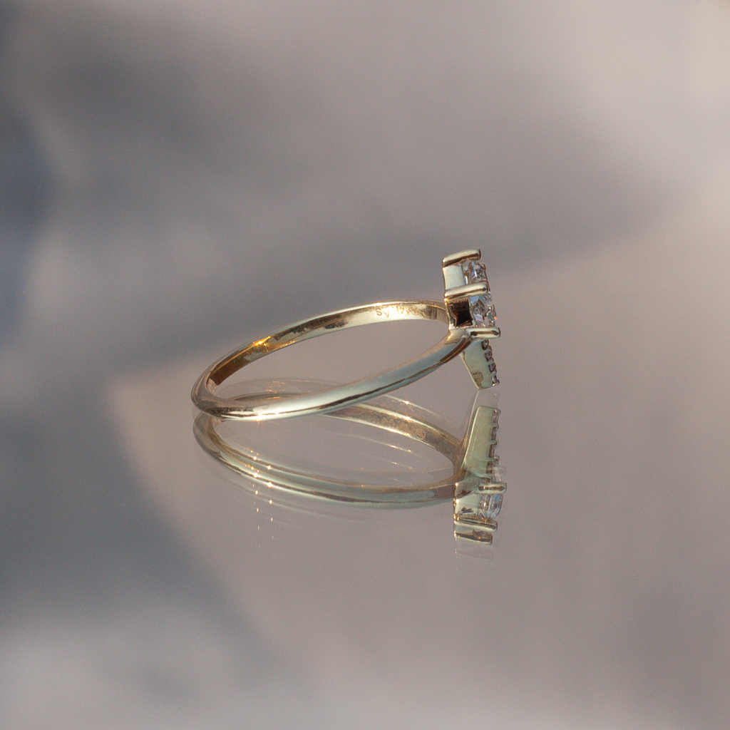 Geometric diamond engagement ring, made with 14k yellow gold and round diamonds.