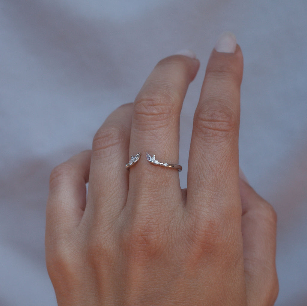 An open white diamond crown wedding band with a gentle wave to trace and pair with any engagement ring, whether it’s a solitaire or a halo. This ring is also a perfect everyday stackable ring that can be stacked with your favourite everyday staples, or worn on its own. Made in 14K white gold.