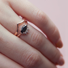 Contemporary take on a traditional marquise diamond ring features an East-West marquise black diamond. The centre stone is surrounded with a diamond crown of marquise and round brilliant diamonds. Made in solid 14k or 18K rose gold. 