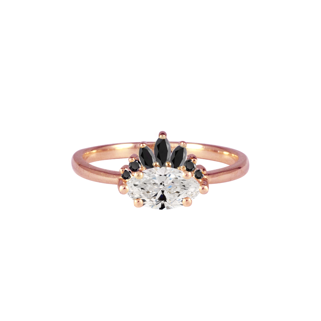 Contemporary take on a traditional marquise diamond ring featuring an East-West marquise brilliant cut diamond. The centre stone is surrounded with a diamond crown of black marquise and round brilliant diamonds. Made in solid 14k or 18K rose gold.