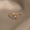 Unique engagement ring, featuring a salt and pepper round rose cut diamond, with diamond cluster, on a split band, made in 14k yellow gold.