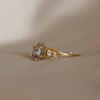Unique engagement ring, featuring a round salt and pepper round rose cut diamond, with diamond cluster, on a split band, made in 14K or 18K yellow gold.
