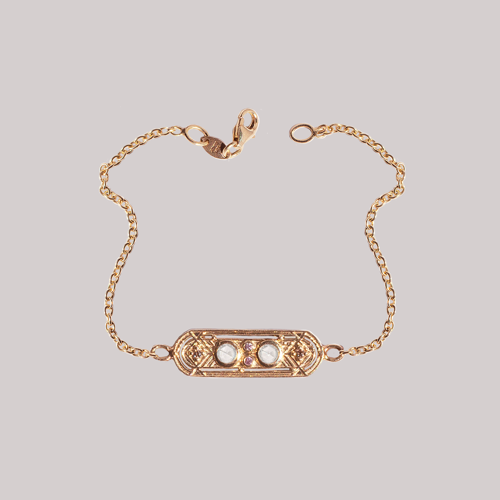 This dainty gold charm bracelet, meant to bring balance to your life, featuring two round rose cut diamonds and encrusted with the tiniest of champagne diamonds and pink sapphires, made in 14K or 18K gold.