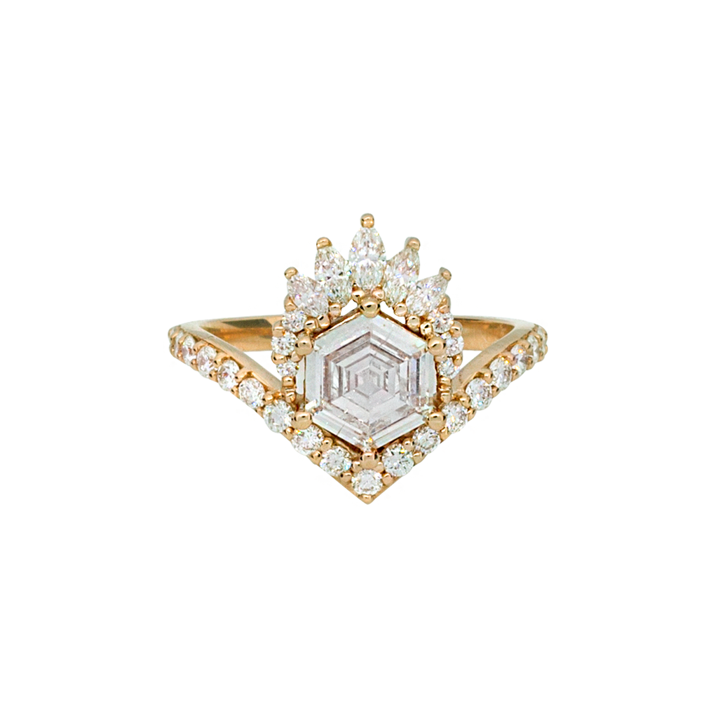 Unique step cut hexagon diamond engagement ring, featuring a delicate V shape band, encrusted with round brilliant diamonds. The hexagon step cut diamond has a low profile setting and is surrounded with a fine crown of marquise and round cut white diamonds. Made in 14k or 18k yellow gold. 
