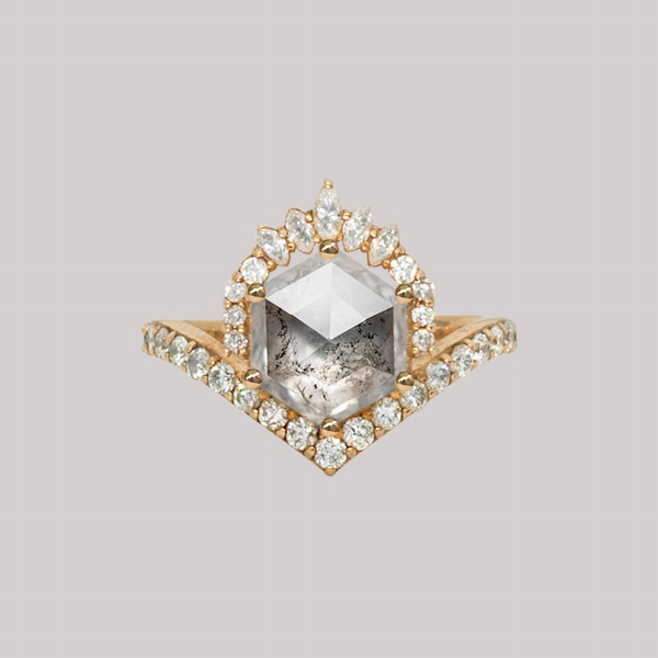 Unique hexagon salt and pepper rose cut diamond engagement ring, featuring a delicate V shape band, encrusted with round brilliant diamonds. The hexagon rose cut diamond has a low profile setting and is surrounded with a fine crown of marquise and round cut white diamonds. Made in 14k or 18k yellow gold. 