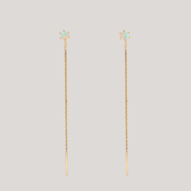 Delicate opal gold threaders, ideal for threading through multiple piercings, feature a six claw prong setting, using 14K gold.