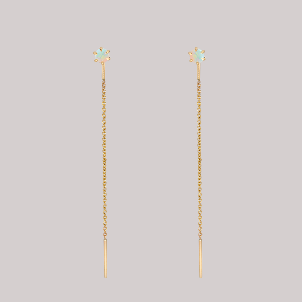 Delicate opal gold threaders, ideal for threading through multiple piercings, feature a six claw prong setting, using 14K gold.