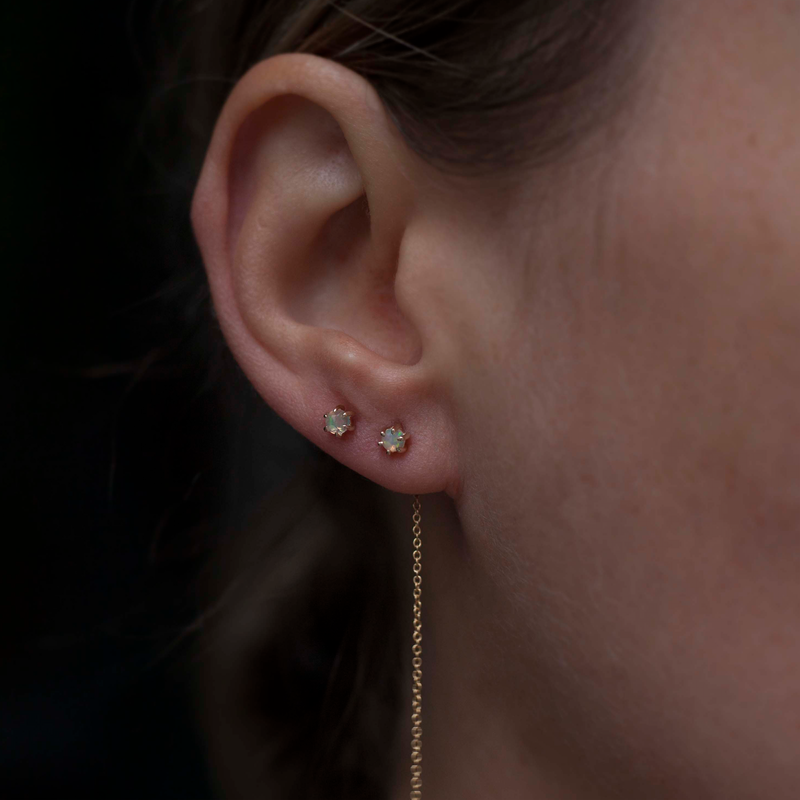 Delicate opal gold threaders, ideal for threading through multiple piercings, feature a six claw prong setting, using 14K gold.