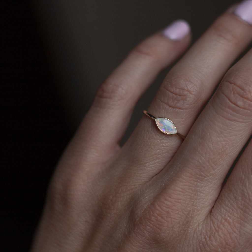 Delicate east west opal marquise everyday ring, made in 14k or 18k yellow gold. 