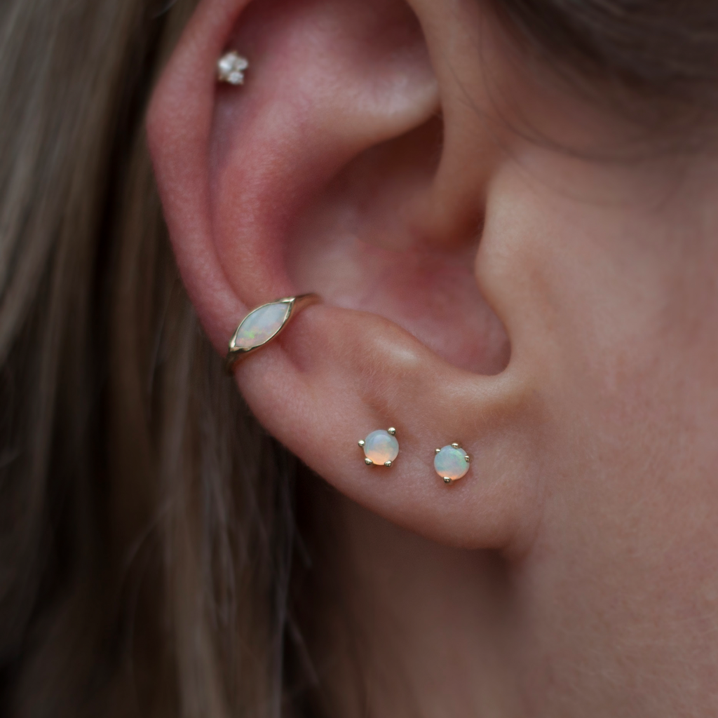 Opal earring studs, in a prong setting, made in 14k or 18k yellow gold.