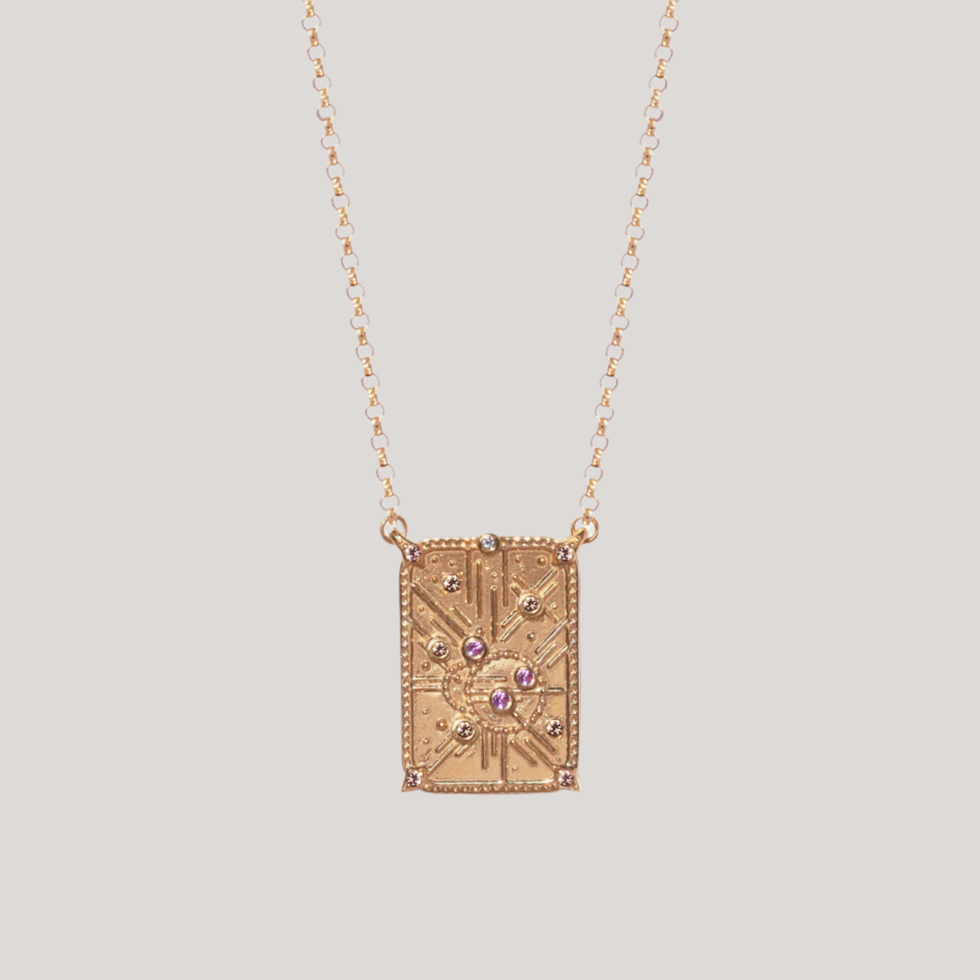 Light code charm, with sacred geometry, made in 14k or 18k gold, with light pink sapphires and champagne diamonds. 