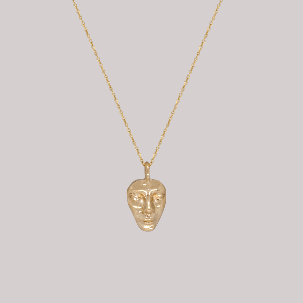 Gold face charm