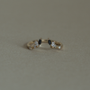An open black and white diamond crown wedding band with a gentle wave to trace and pair with any engagement ring, whether it’s a solitaire or a halo. This ring is also a perfect everyday stackable ring that can be stacked with your favourite everyday staples, or worn on its own. Made in 14K or 18K yellow gold.