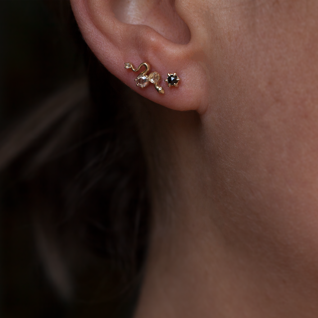 Delicate gold snake earring studs, featuring round rose cut diamonds, made in 14K yellow gold. Perfect studs to layer, mix and match. 